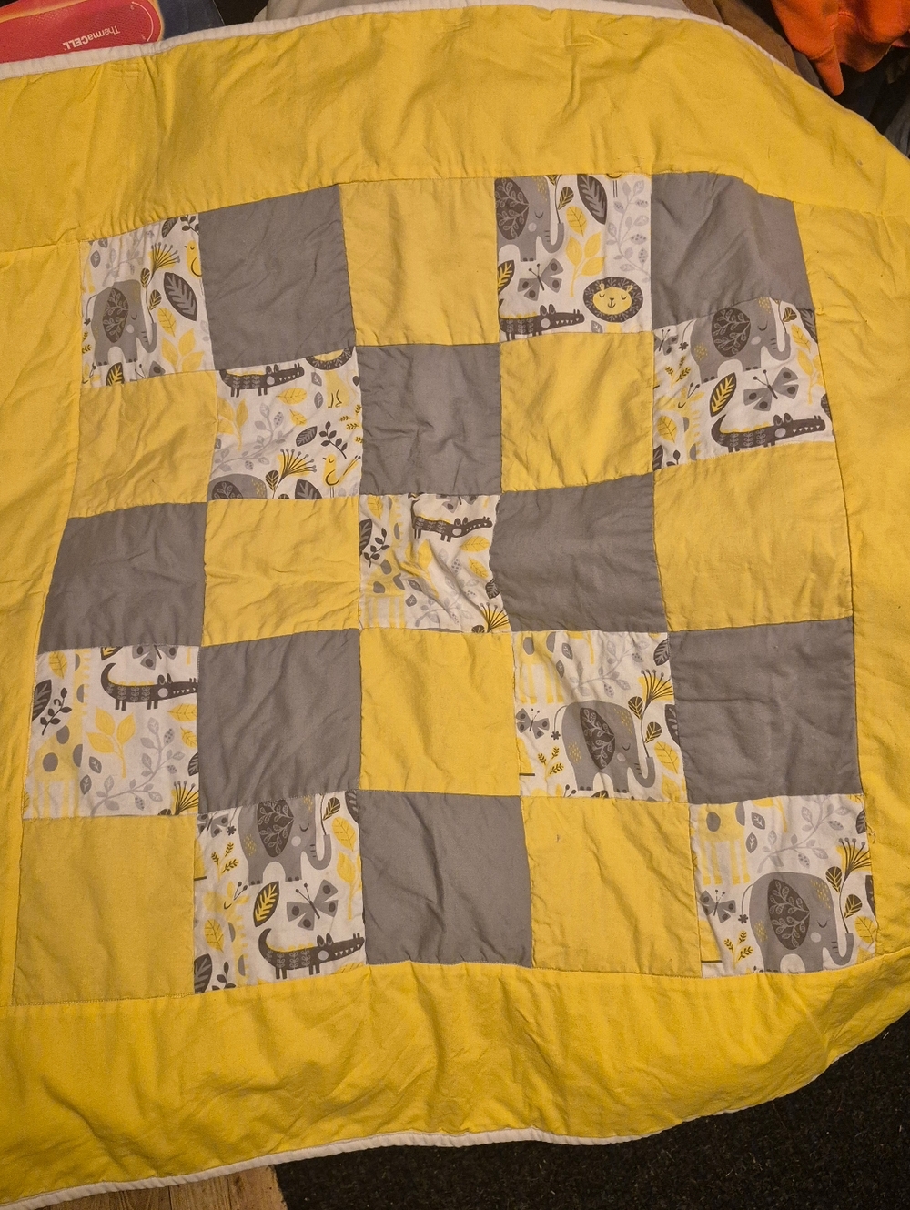 Handcrafted yellow & grey patchwork baby throw quilt featuring animal patterns